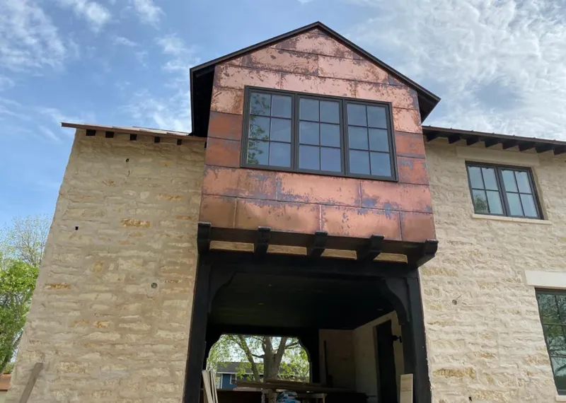 Copper metal panel facade on a stone building for Skylight Installation in Semmes